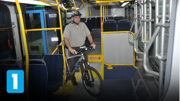 Cyclist bringing bicycle through rear doors of bus
